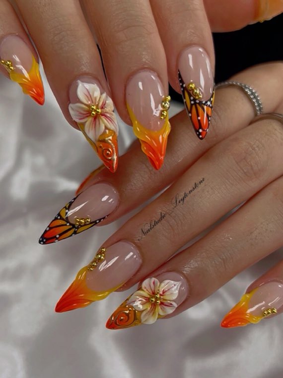 Orange and yellow stiletto nails with monarch butterfly and 3D flowers