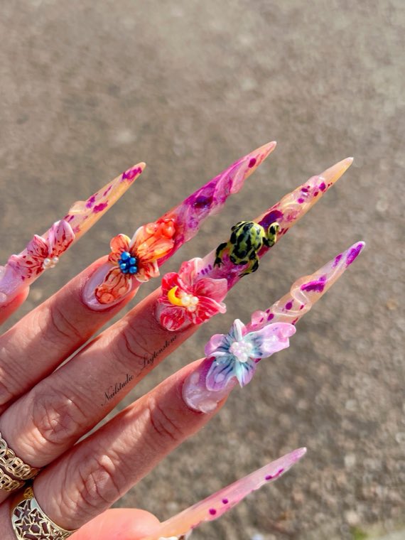 Colourful extra-long stiletto nails with 3D flowers and a frog charm